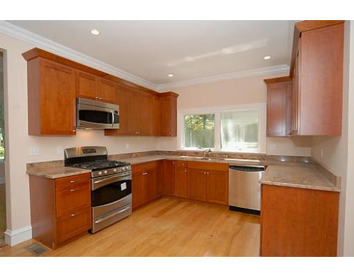 42 Nickerson Road Newton, MA 02467 - Photo 9 of 28 a kitchen with stainless steel appliances granite countertop a stove a sink a microwave a refrigerator and cabinets