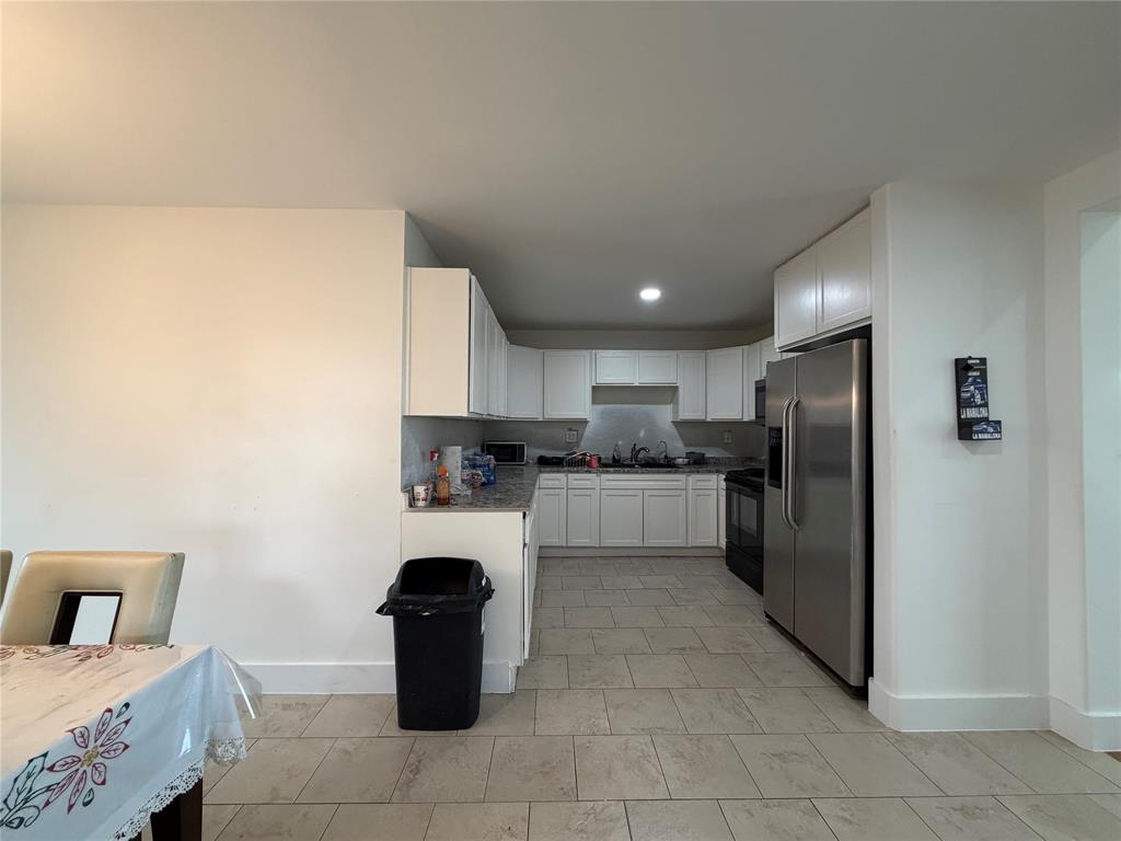 2552 Northwest 1090 Road Corsicana, TX 75110 - Photo 12 of 23 a kitchen with a refrigerator and a sink