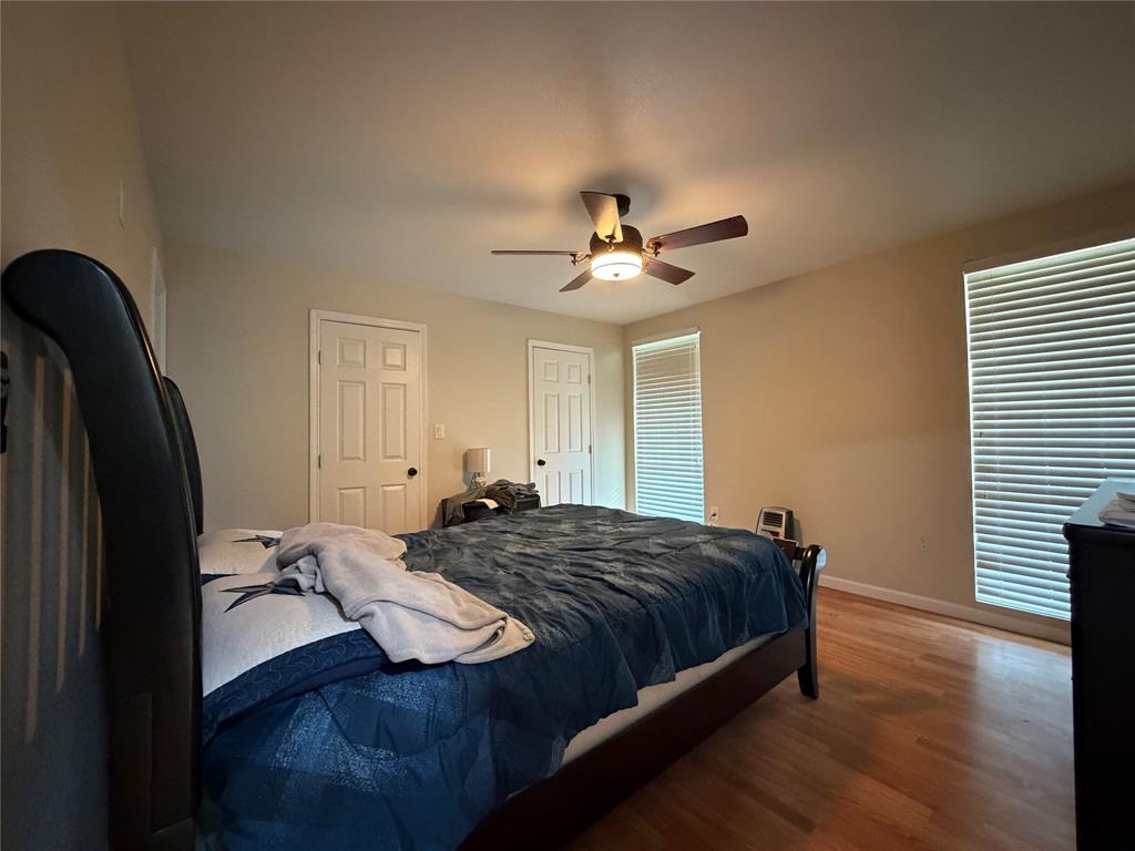 2552 Northwest 1090 Road Corsicana, TX 75110 - Photo 13 of 23 a bedroom with a bed and a chandelier