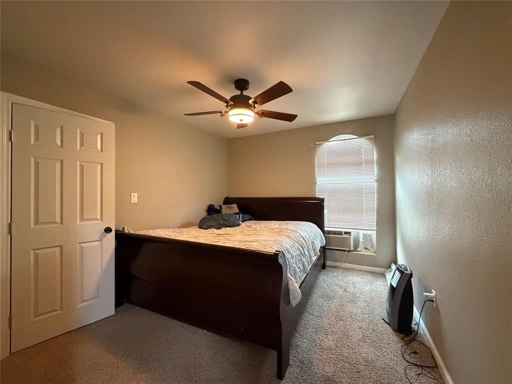 2552 Northwest 1090 Road Corsicana, TX 75110 - Photo 16 of 23 a bed room with a bed and a ceiling fan