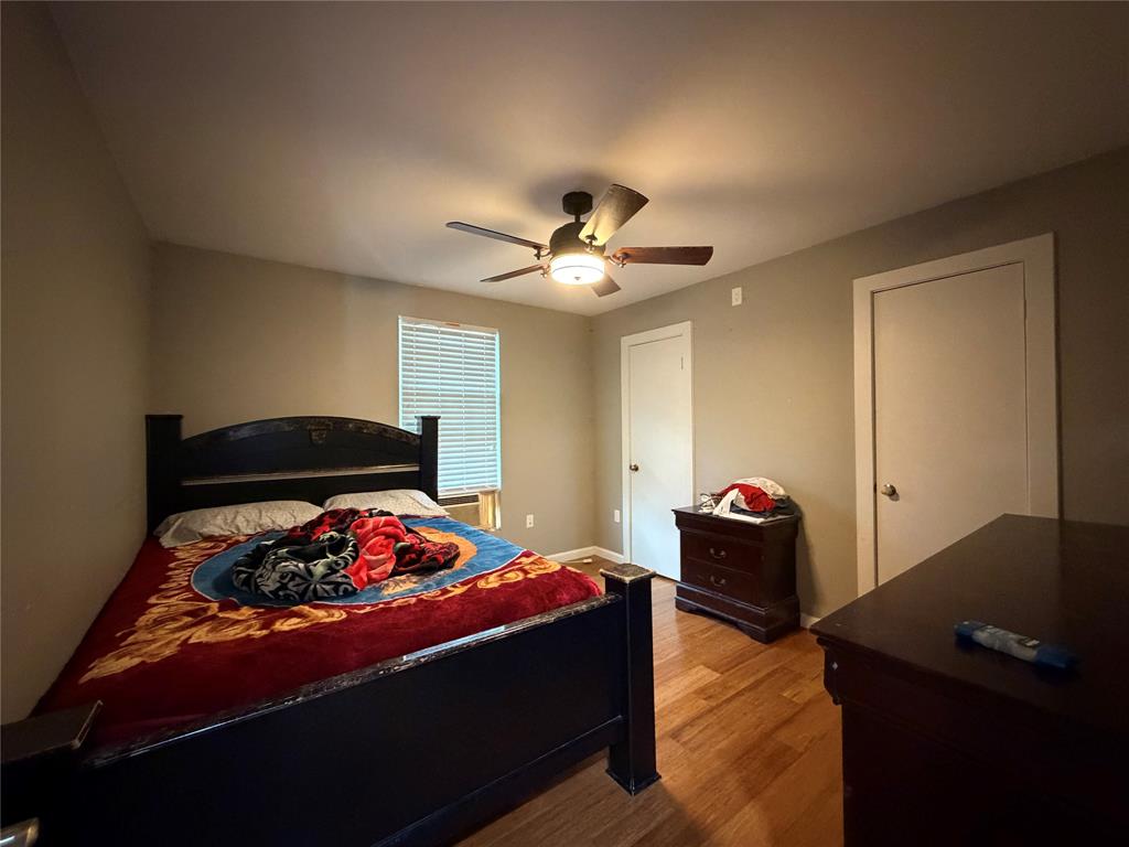 2552 Northwest 1090 Road Corsicana, TX 75110 - Photo 17 of 23 a bedroom with bed and a chandelier