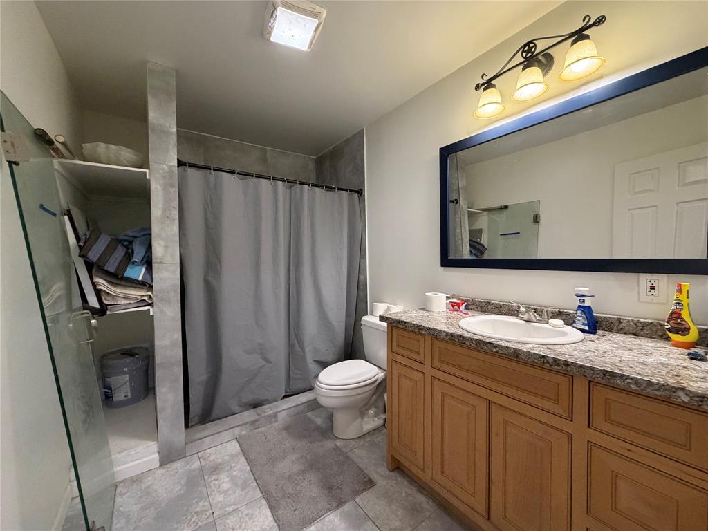 2552 Northwest 1090 Road Corsicana, TX 75110 - Photo 18 of 23 a bathroom with a toilet sink and mirror
