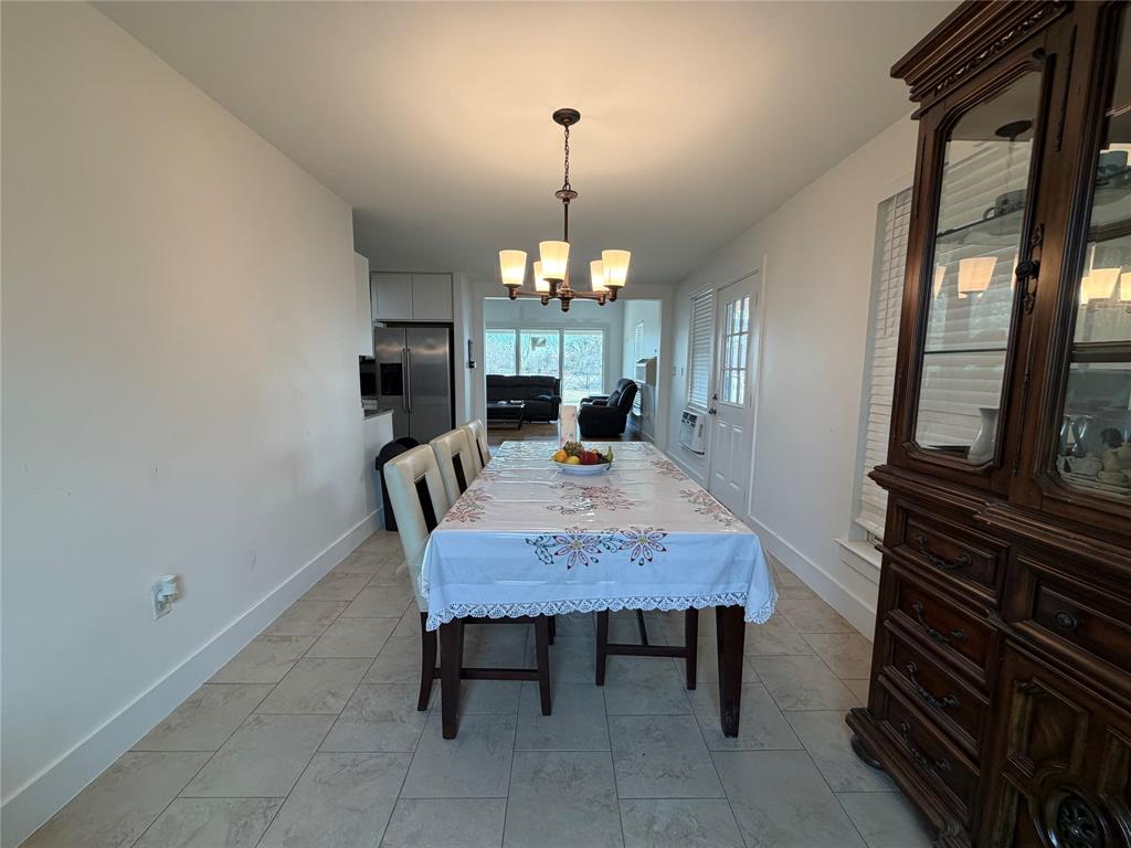 2552 Northwest 1090 Road Corsicana, TX 75110 - Photo 9 of 23 a view of a dining room with furniture window and wooden floor