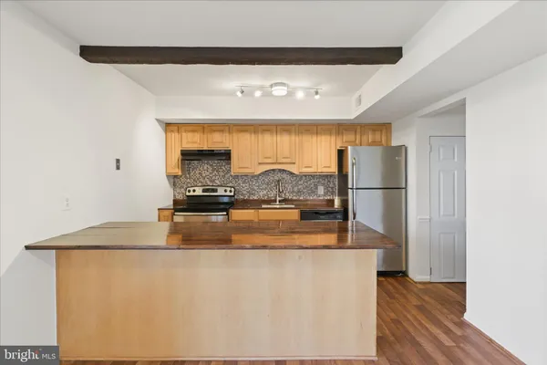 a view of a refrigerator in kitchen and wooden floor