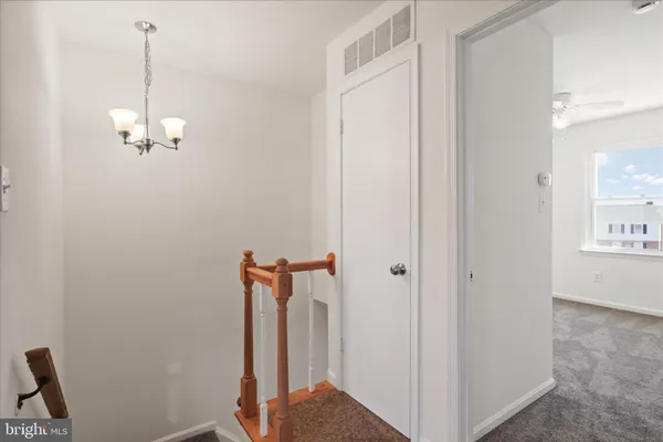 an empty room with window and ceiling fan