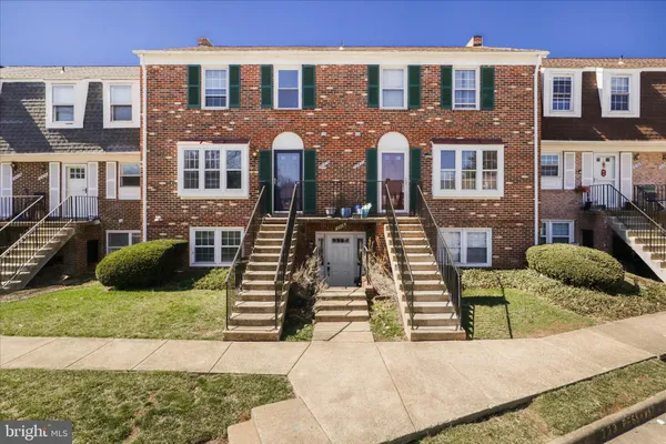 a front view of a residential apartment building with a yard