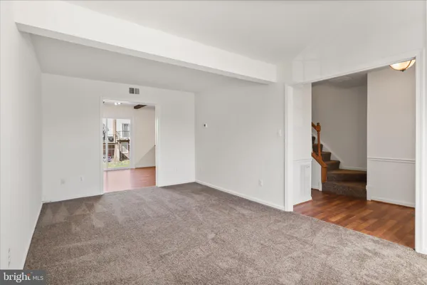 a view of empty room with wooden floor and cabinet