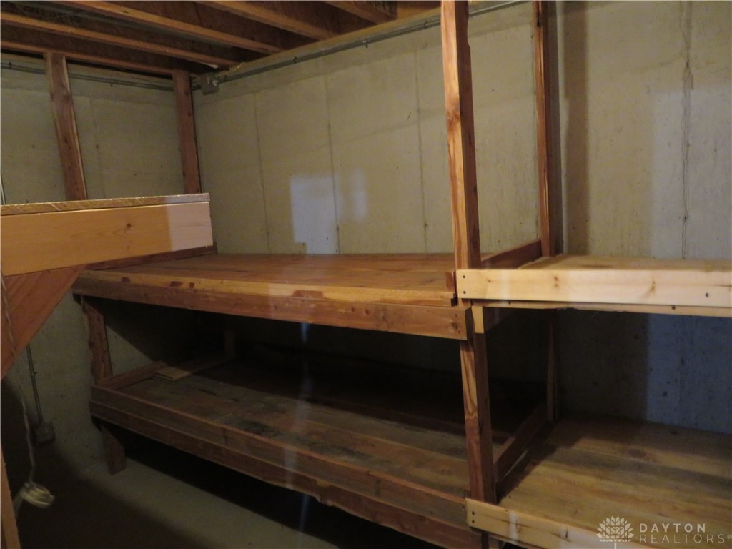 748 Inlow Avenue Peebles, OH 45660 - Photo 26 of 61 This versatile basement space offers ample storage solutions with sturdy wooden shelving.