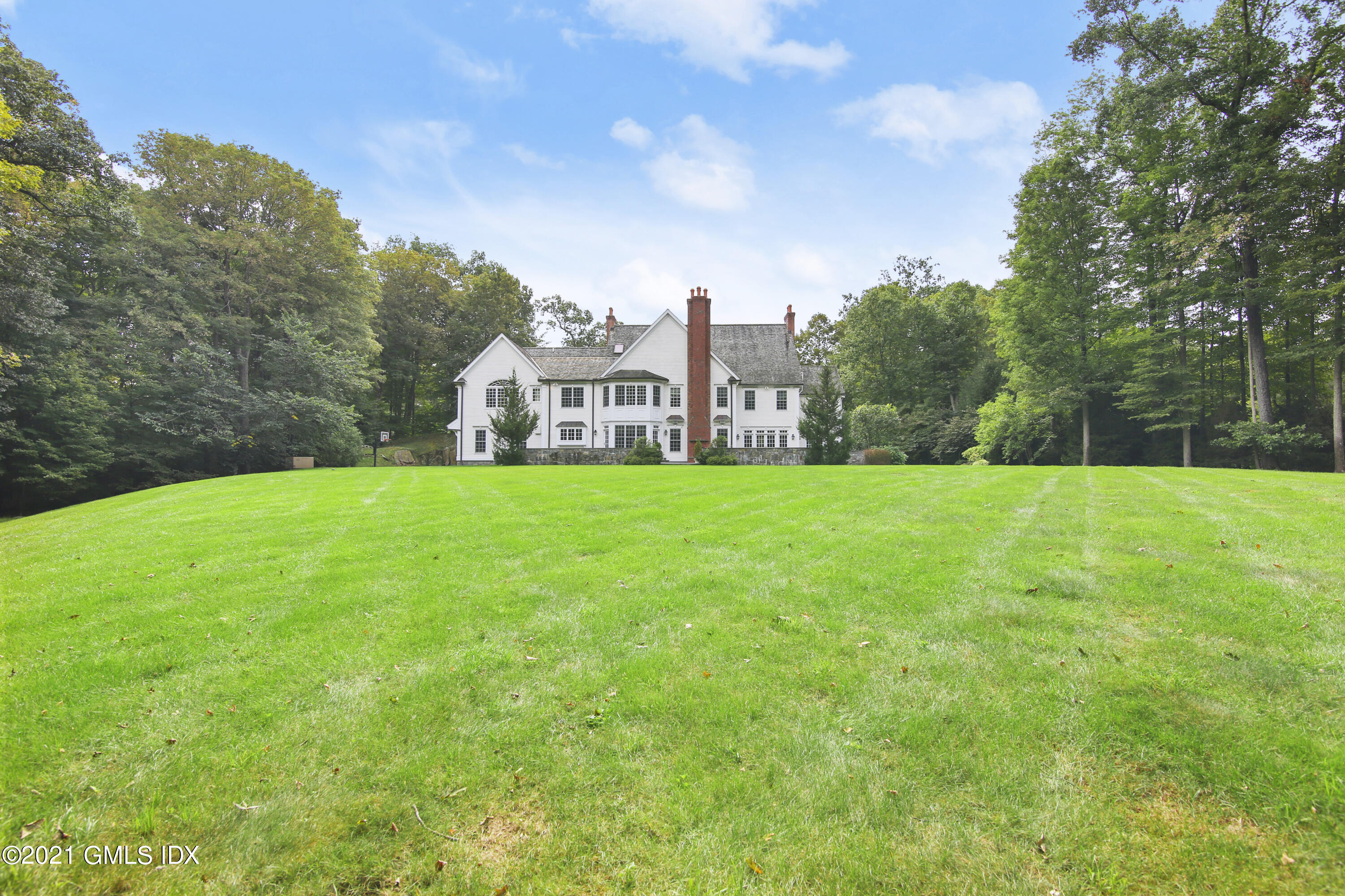 50 Byfield Lane Greenwich, CT 06830 - Photo 11 of 37 a view of a park with a house in the background
