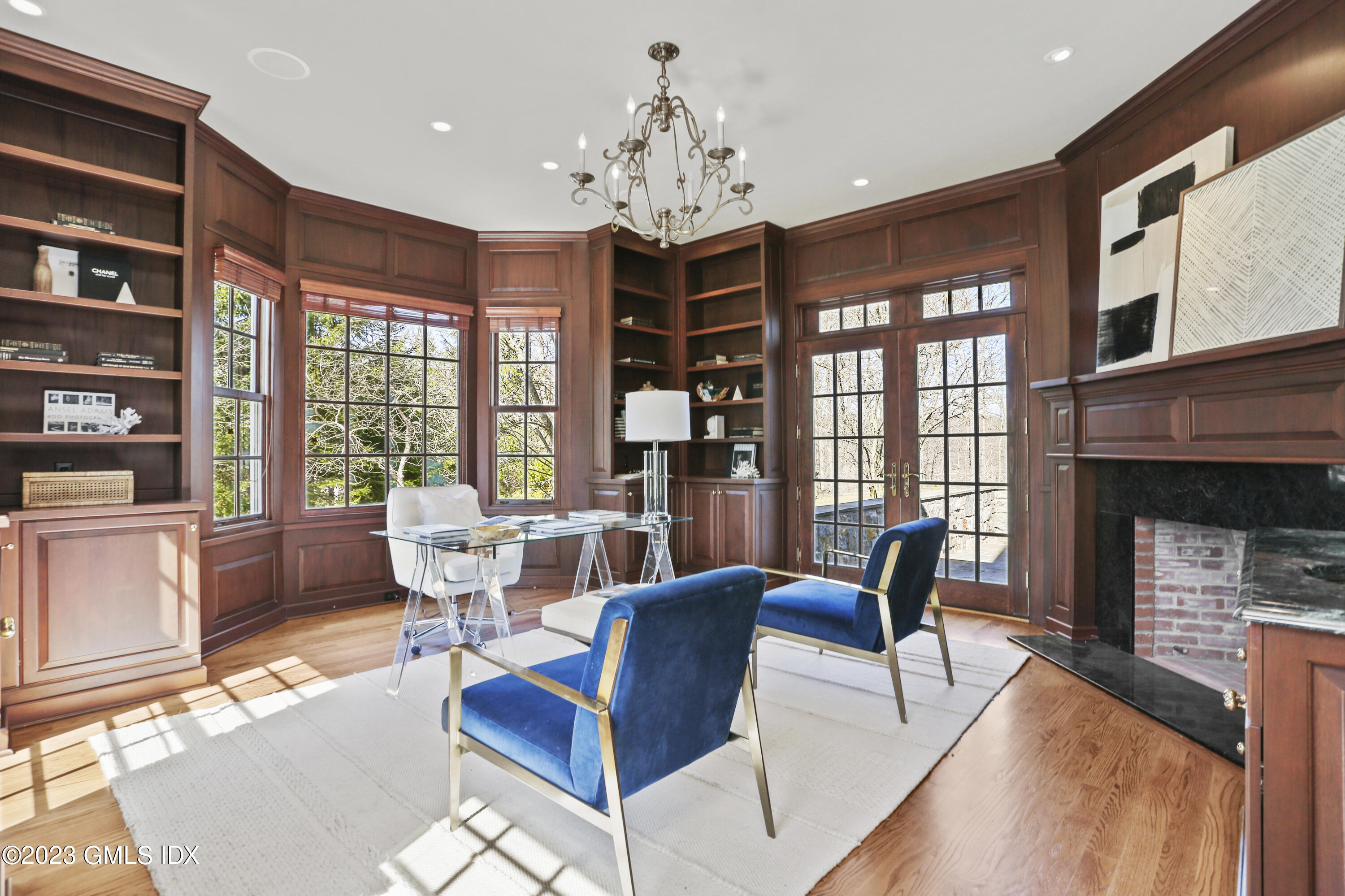 50 Byfield Lane Greenwich, CT 06830 - Photo 13 of 37 a living room with furniture a flat screen tv and a large window