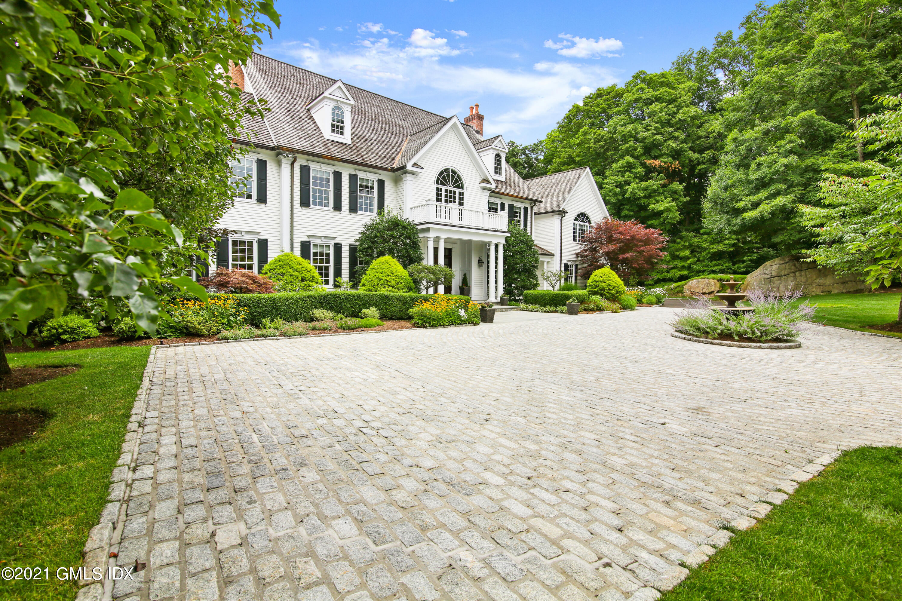 50 Byfield Lane Greenwich, CT 06830 - Photo 2 of 37 a front view of a house with a yard and trees