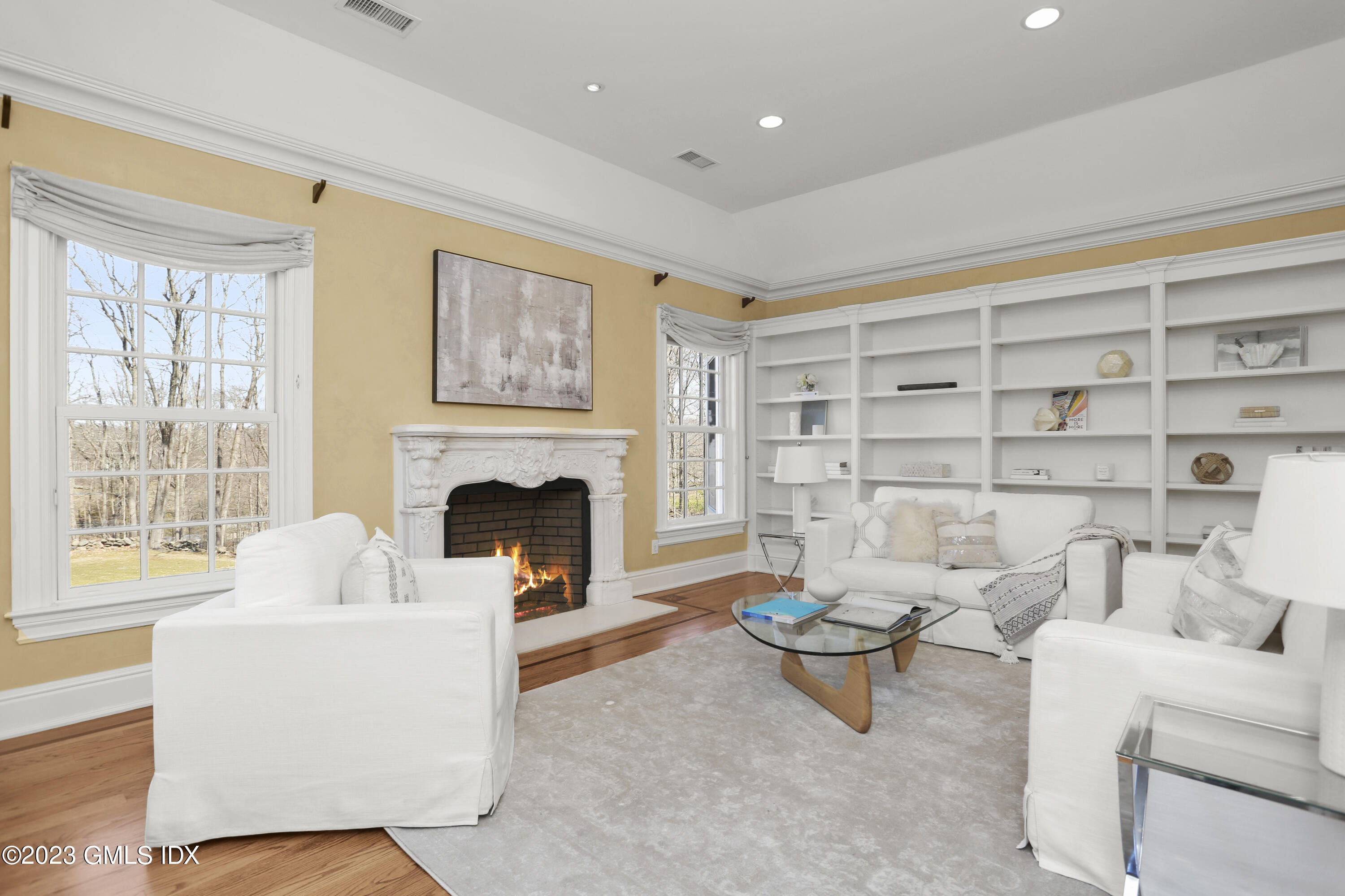 50 Byfield Lane Greenwich, CT 06830 - Photo 21 of 37 a living room with furniture a fireplace and a large window