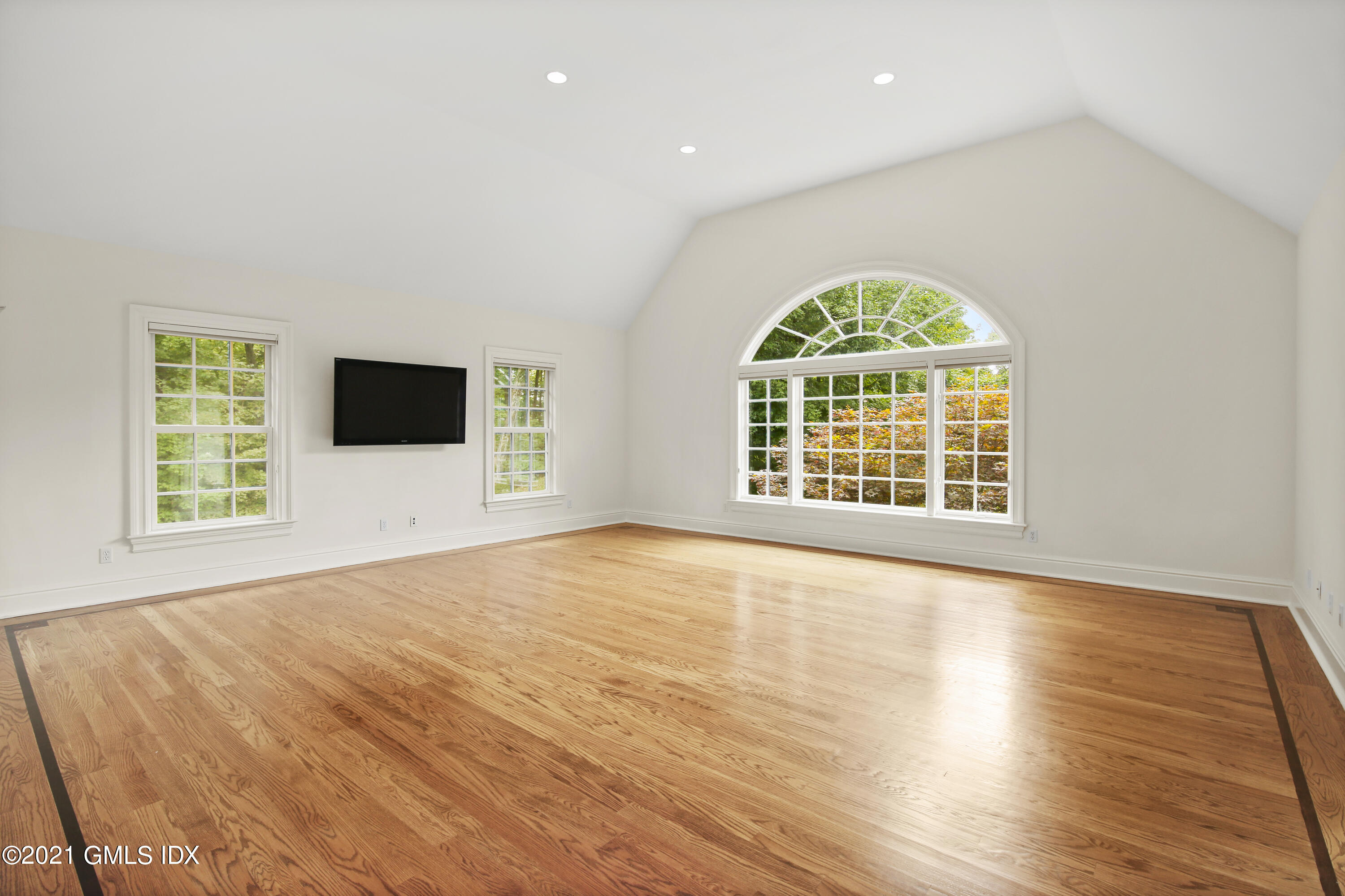 50 Byfield Lane Greenwich, CT 06830 - Photo 22 of 37 a view of an empty room with a window and wooden floor