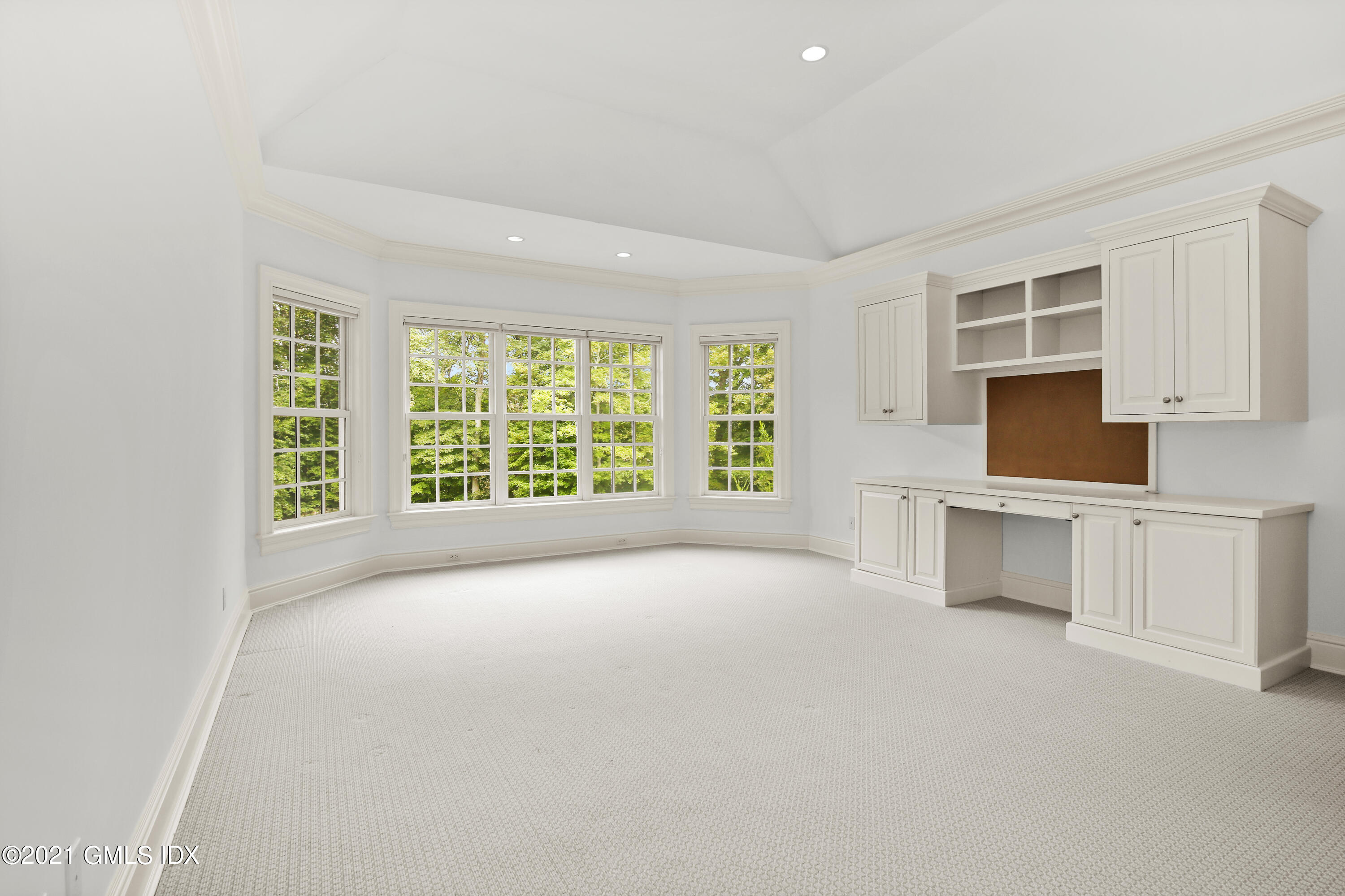 50 Byfield Lane Greenwich, CT 06830 - Photo 23 of 37 a view of an empty room with a window and kitchen view