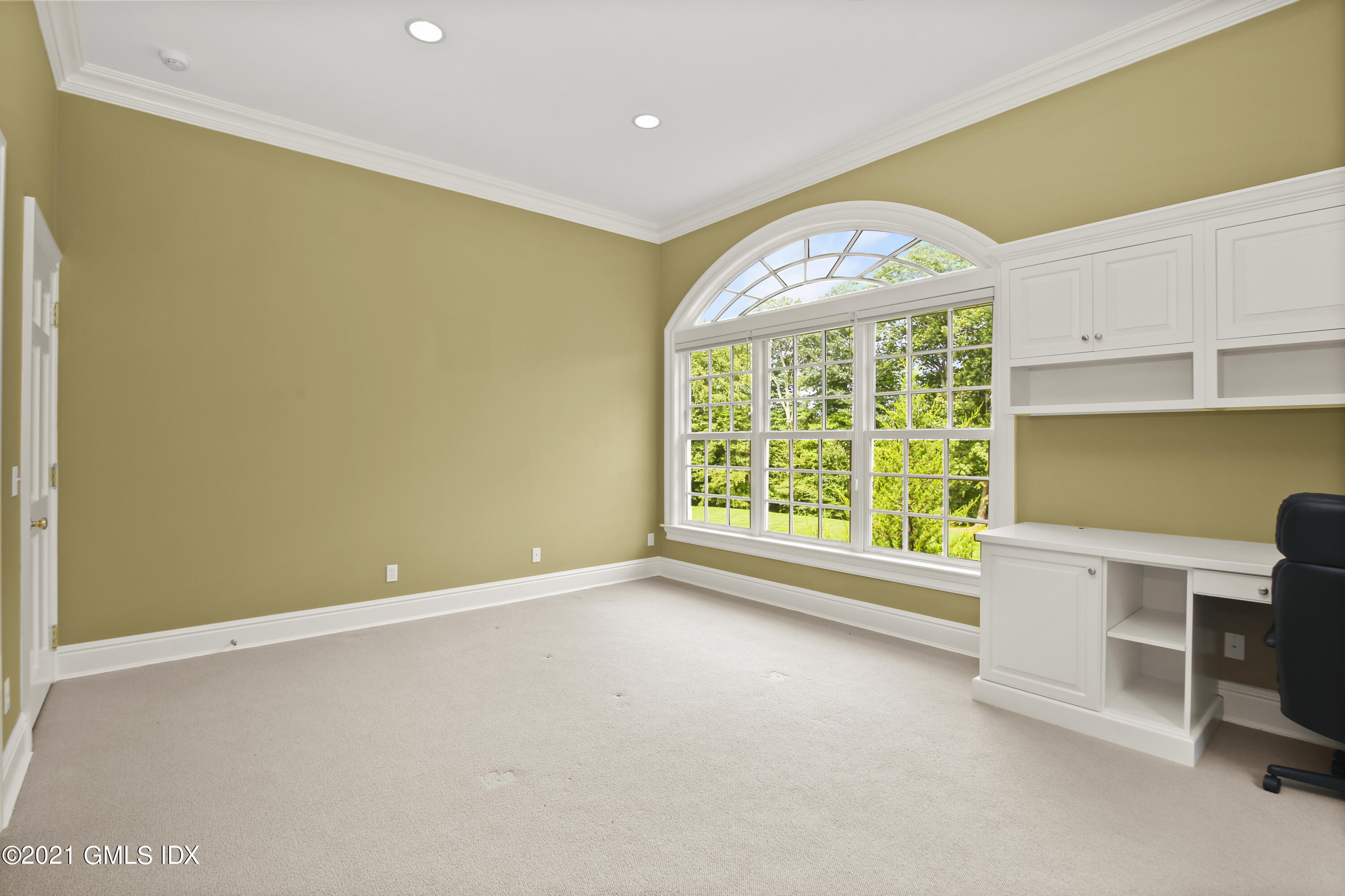 50 Byfield Lane Greenwich, CT 06830 - Photo 25 of 37 an empty room with a fireplace and a window