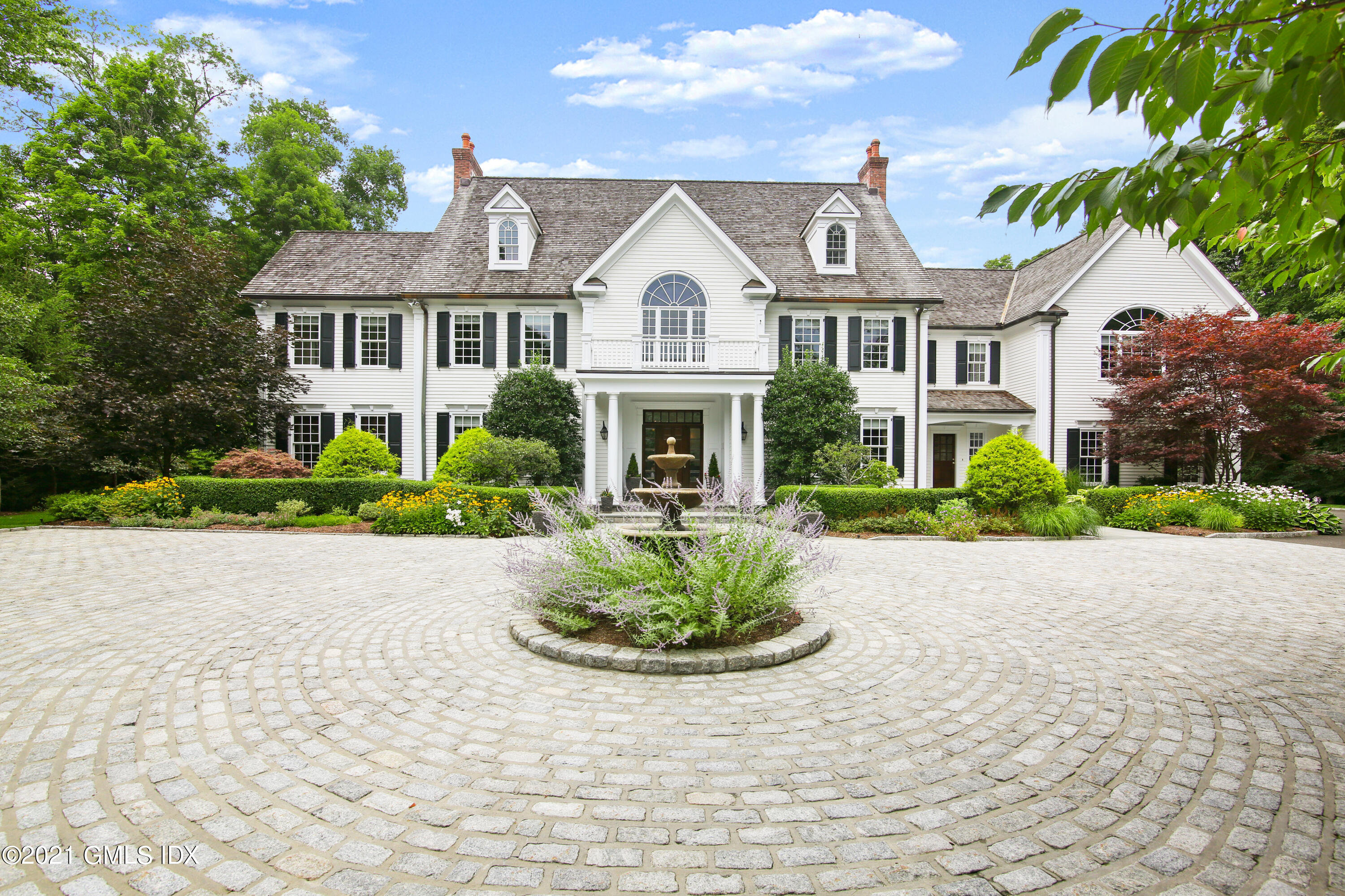 50 Byfield Lane Greenwich, CT 06830 - Photo 3 of 37 a front view of a house with a garden and plants
