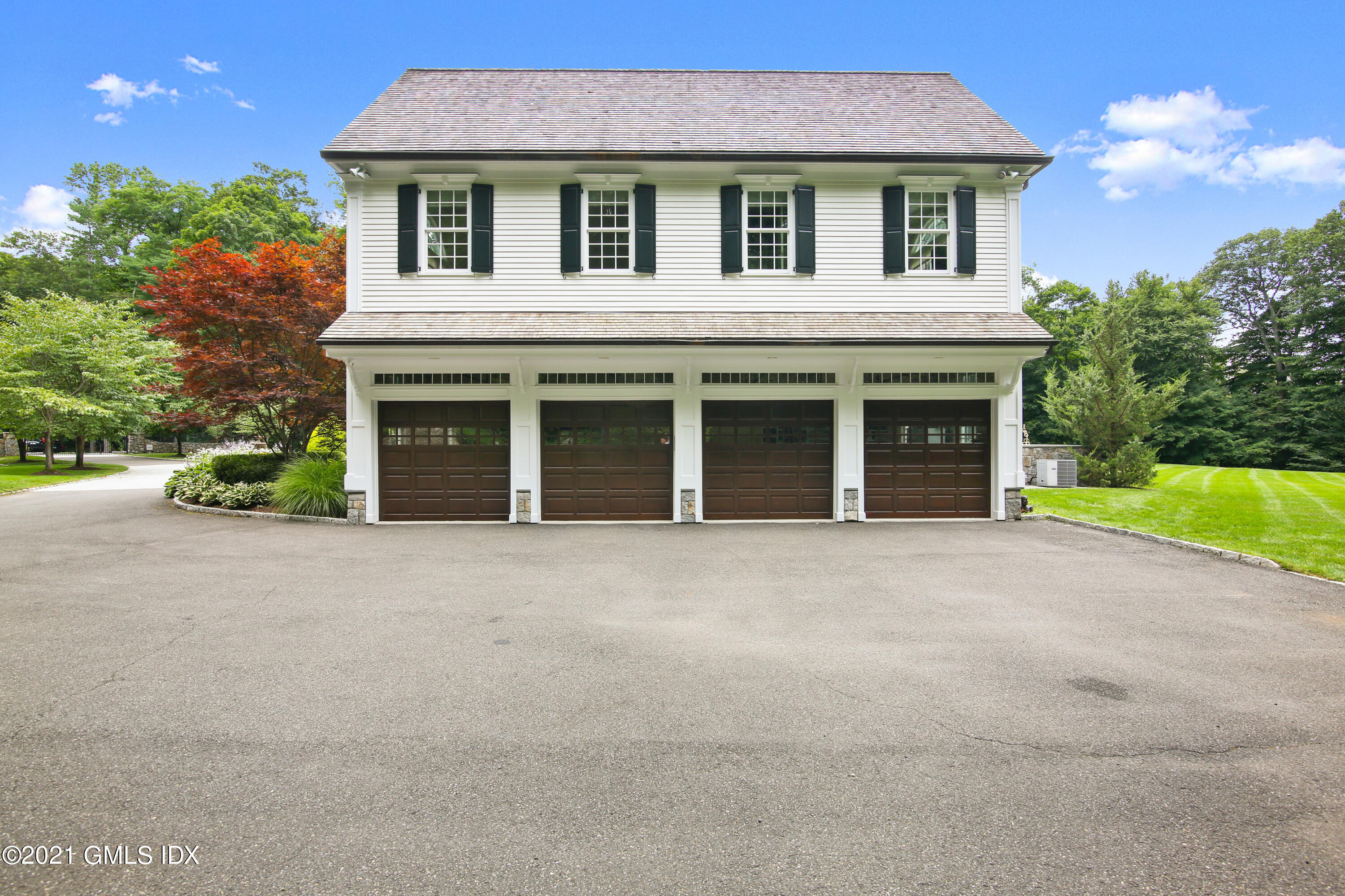 50 Byfield Lane Greenwich, CT 06830 - Photo 10 of 37 a view of a house with a yard and potted plants