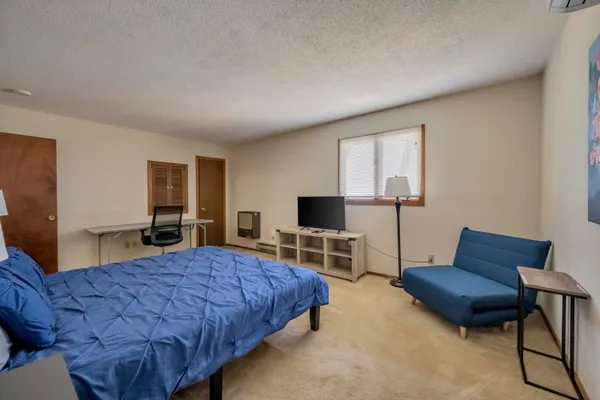 a bedroom with bed and chair