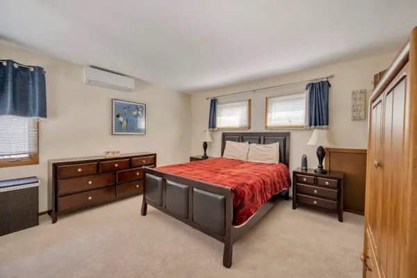 a bedroom with a bed and a dresser