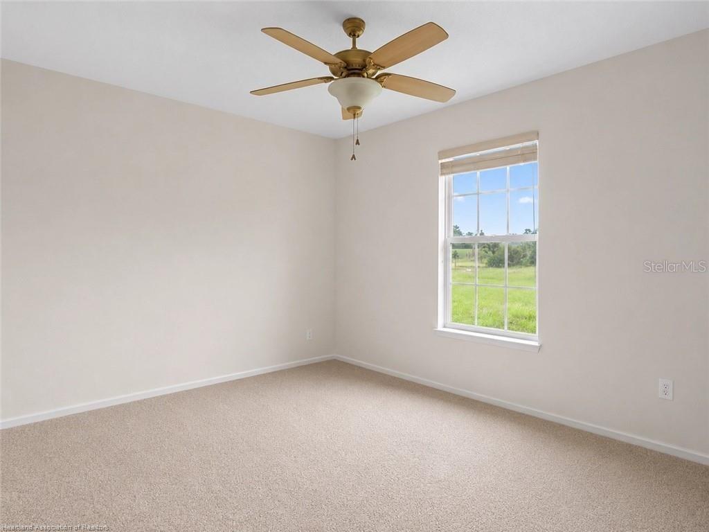 30 Milky Way Venus, FL 33960 - Photo 17 of 47 an empty room with a window and a fan