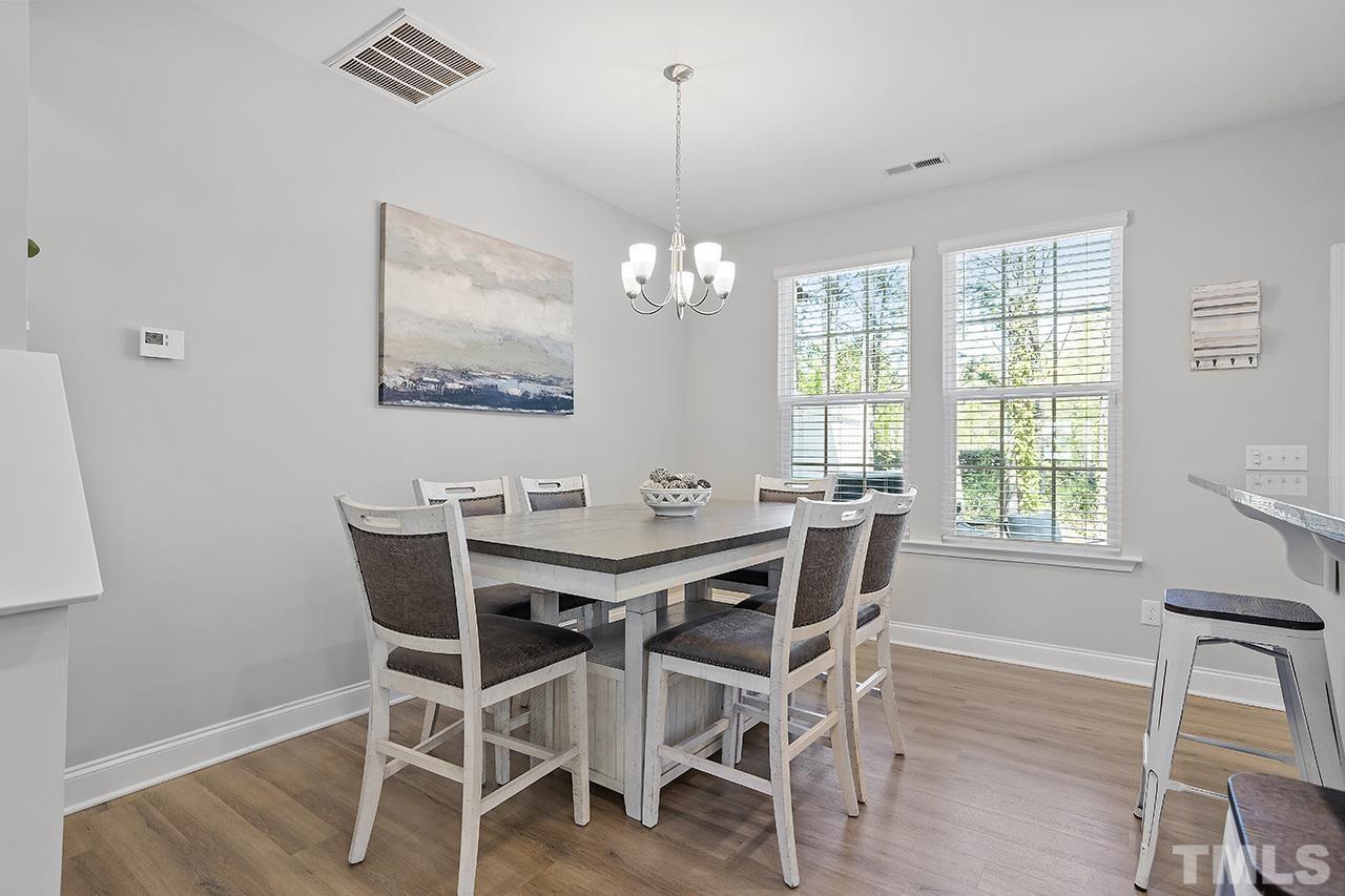 5703 Princess Curry Way Raleigh, NC 27610 - Photo 17 of 33 a view of a dining room with furniture window and wooden floor