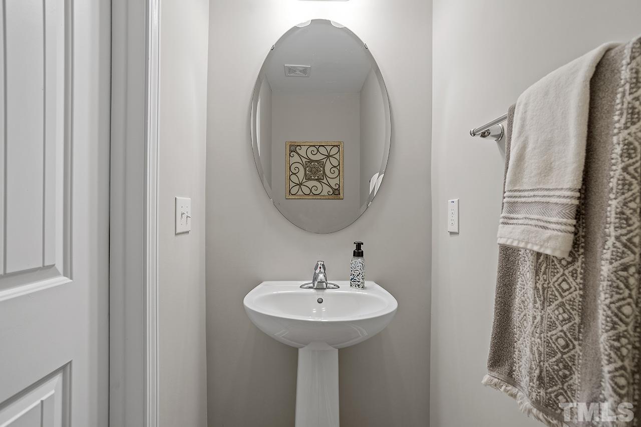 5703 Princess Curry Way Raleigh, NC 27610 - Photo 18 of 33 a bathroom with a sink and mirror