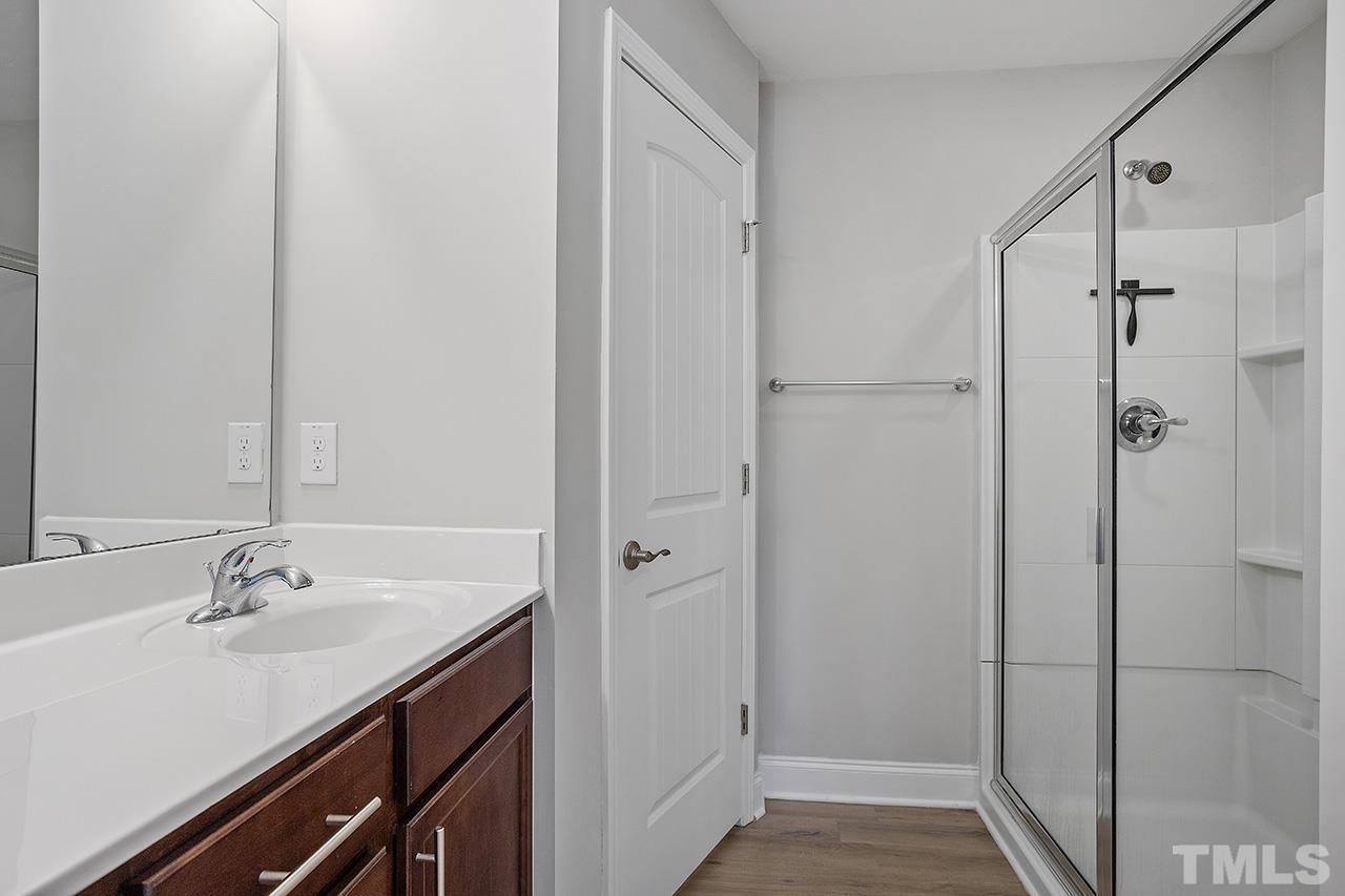 5703 Princess Curry Way Raleigh, NC 27610 - Photo 24 of 33 a bathroom with a sink and a mirror