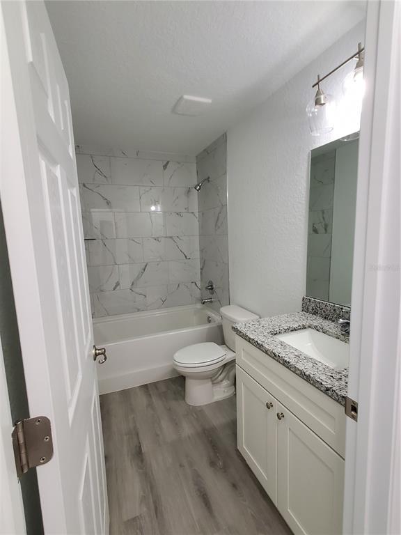 9529 Bahia Road Ocala, FL 34472 - Photo 12 of 20 a bathroom with a granite countertop sink toilet a mirror and bathtub