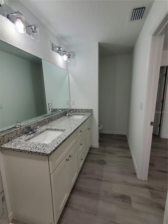 9529 Bahia Road Ocala, FL 34472 - Photo 13 of 20 a bathroom with a granite countertop sink and a mirror