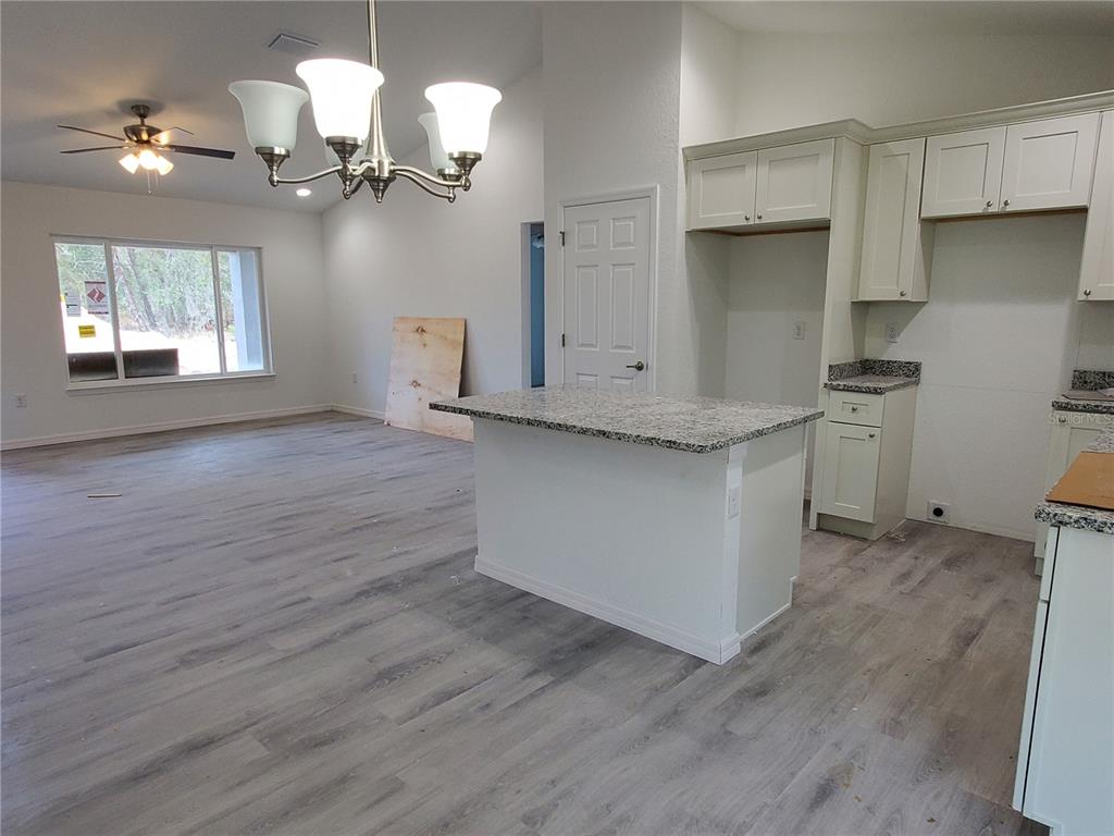 9529 Bahia Road Ocala, FL 34472 - Photo 4 of 20 a kitchen with stainless steel appliances granite countertop a dishwasher a stove and a wooden floors