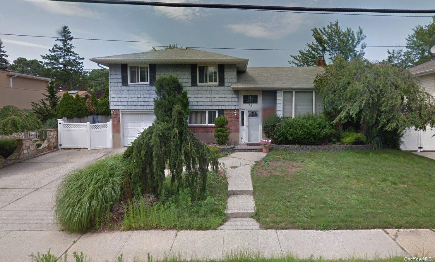 73 Convent Road Syosset, NY 11791 - Photo 1 of 1 a front view of a house with garden