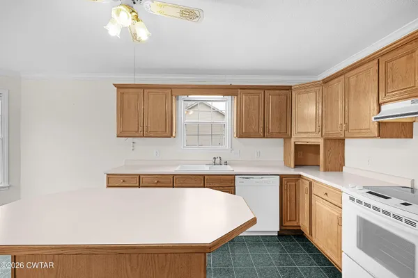a kitchen with a sink cabinets and window