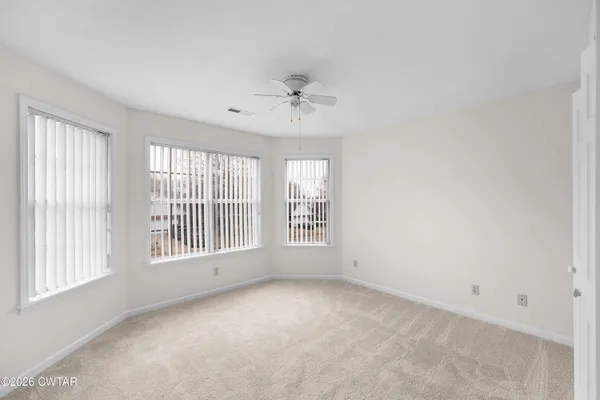 a view of an empty room with a window