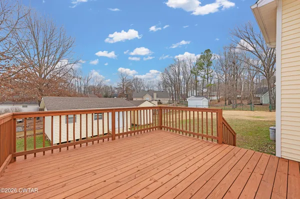 a view of balcony with wooden floor and fence