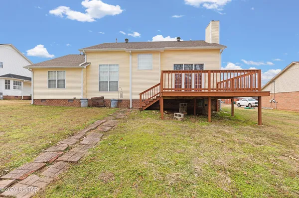 a view of a house with a yard and sitting area