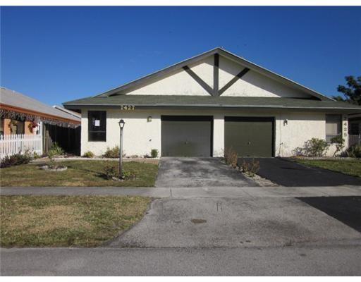 7427 Southwest 13th Street North Lauderdale, FL 33068 - Photo 1 of 49 a front view of a house with a yard