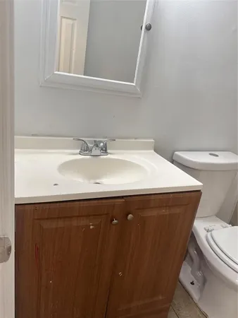 a bathroom with a sink a toilet and a mirror