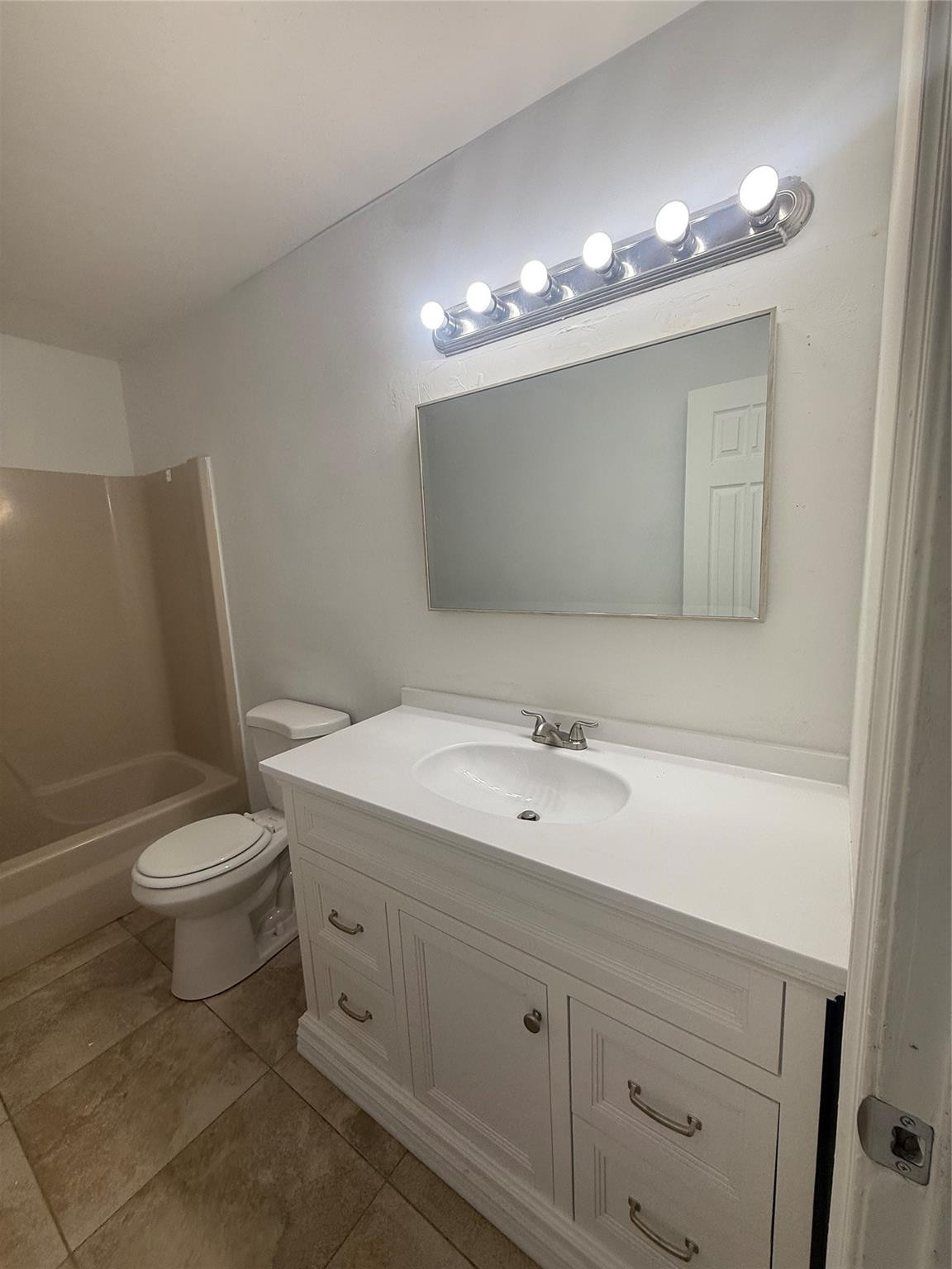 7427 Southwest 13th Street North Lauderdale, FL 33068 - Photo 8 of 49 a bathroom with a toilet a sink a light fixture and mirror