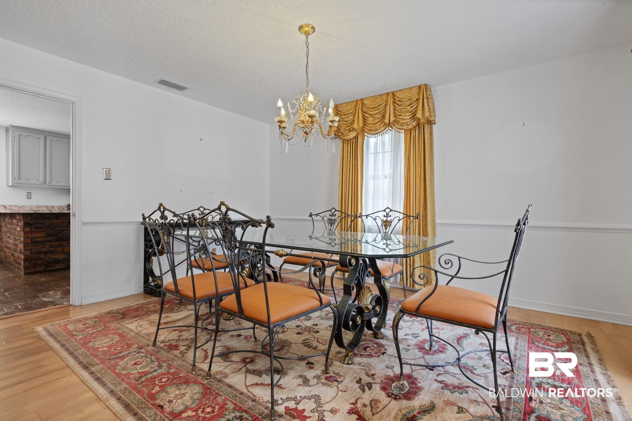 6261 Old Pascagoula Road Theodore, AL 36582 - Photo 20 of 29 Dining room featuring a textured ceiling, an inviting chandelier, and light hardwood / wood-style flooring