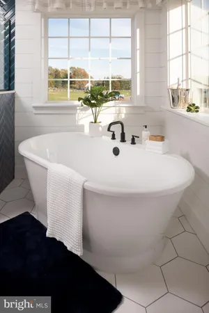 a bath tub sitting in a bathroom next to a window