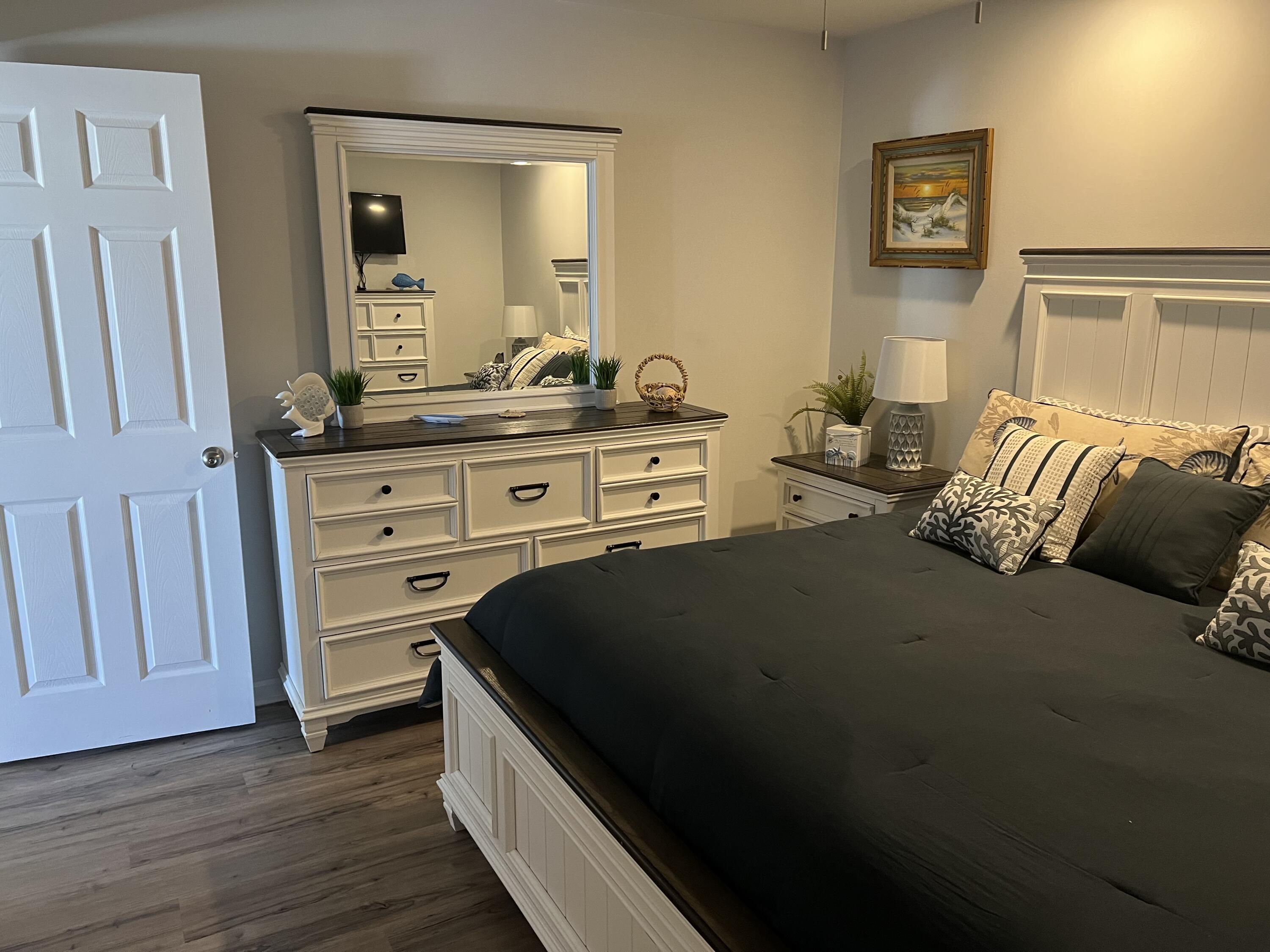a bedroom with a bed and a dresser