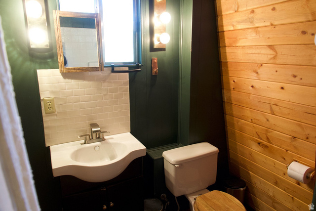 140 East Rim Road Duck Creek Village, UT 84762 - Photo 29 of 45 Bathroom with vanity and wood walls