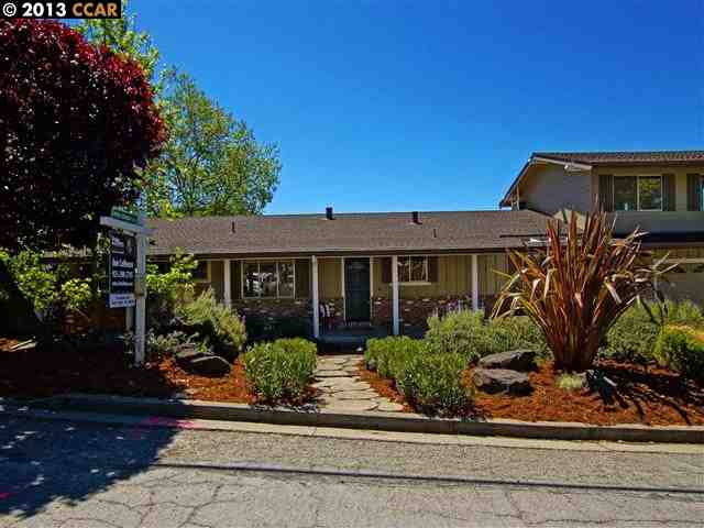 front view of a house with potted plants
