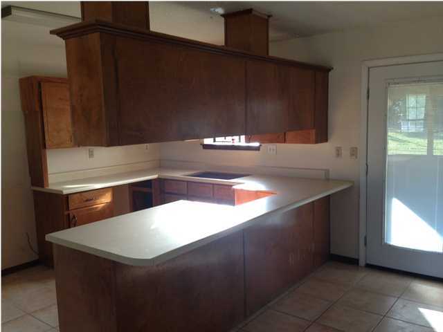 5806 Flamingo Road Crestview, FL 32539 - Photo 10 of 19 a kitchen with a sink and a refrigerator