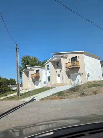 a kitchen with stainless steel appliances granite countertop a sink refrigerator and cabinets