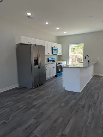 a view of a hallway with wooden floor