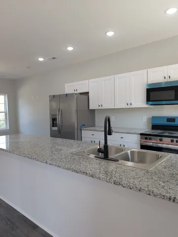 a view of an empty room and wooden floor