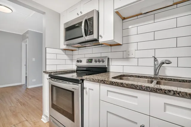 a kitchen with appliances and cabinets