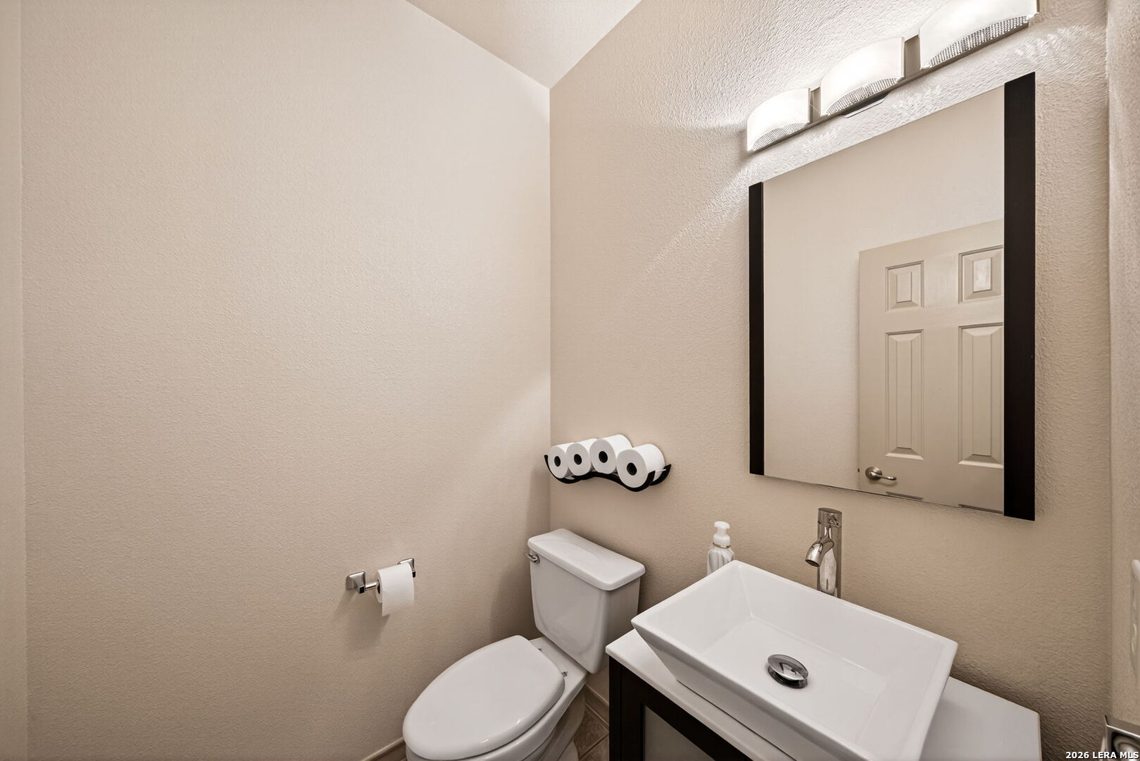 17431 Helotes Spring Road Helotes, TX 78023 - Photo 22 of 50 a bathroom with a toilet sink and mirror