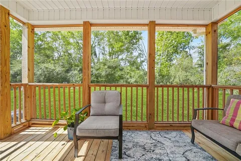 a view of balcony with wooden floor and seating space